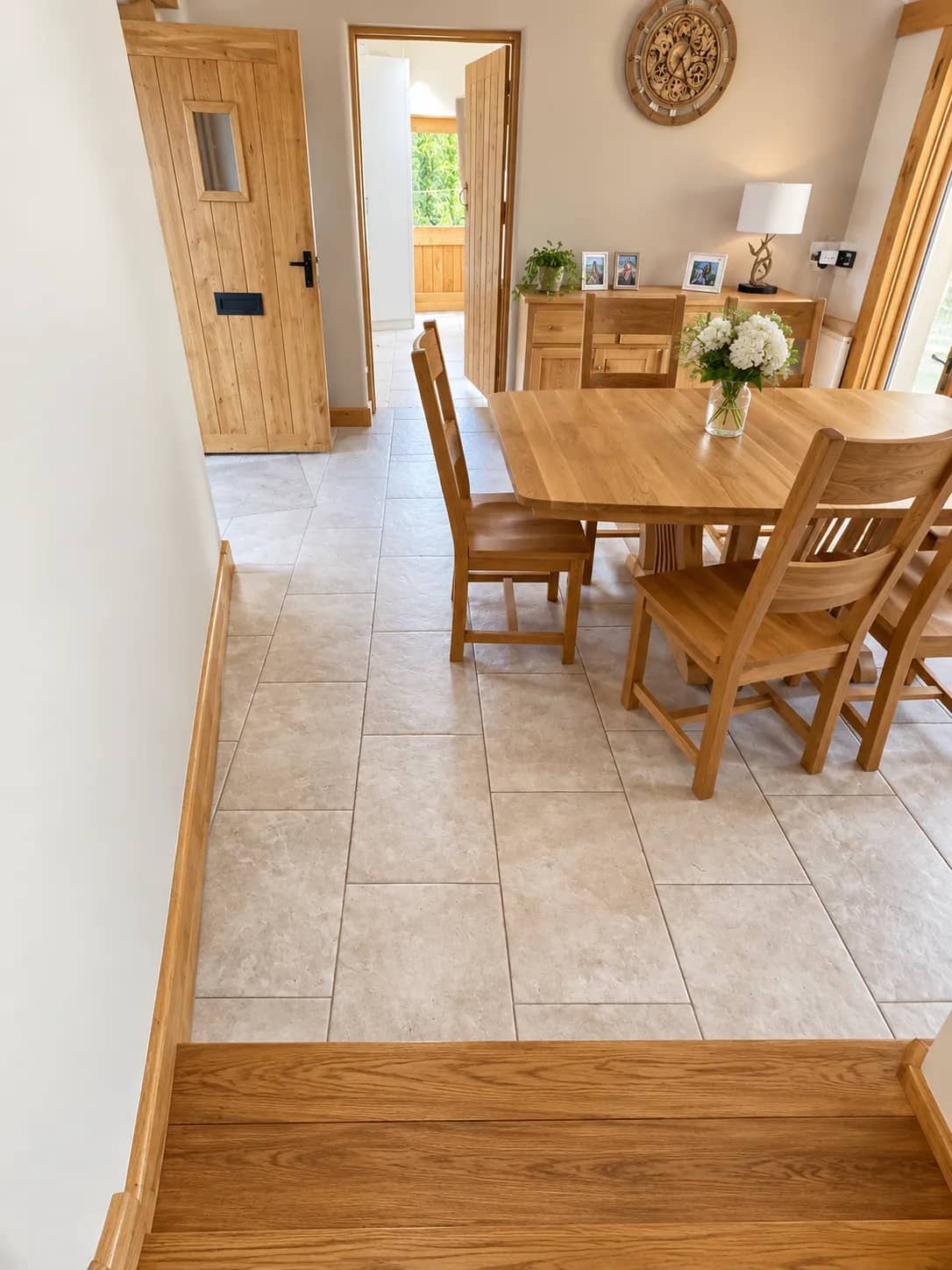A tiled hallway floor left clean leading through to the dining room.