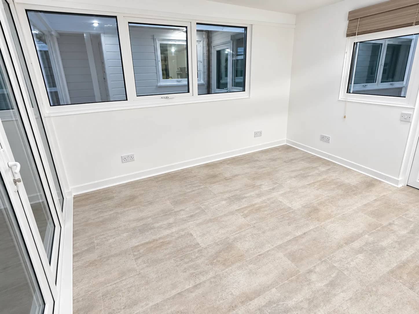 A room carpet left clean beside large windows.