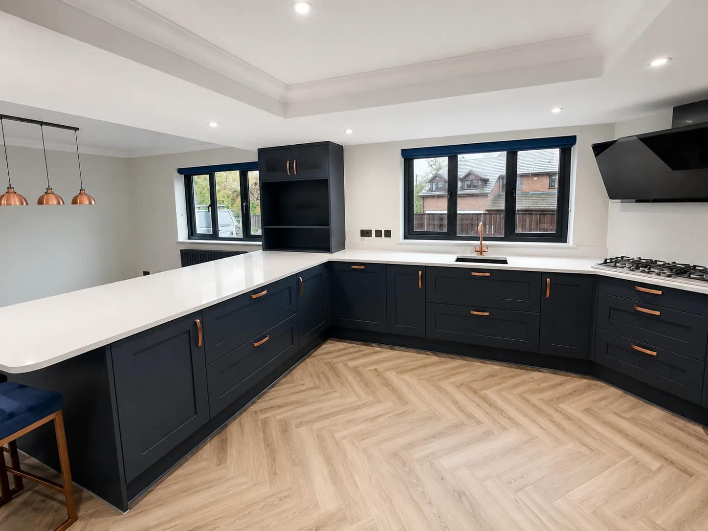 Deep-cleaned kitchen with clear worktops, cabinetry, and herringbone flooring