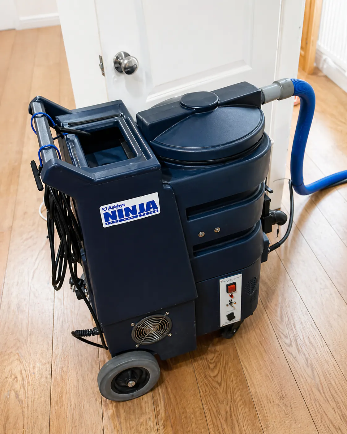 Professional carpet cleaning extraction machine inside a home.